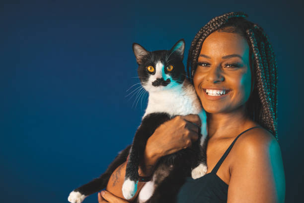 istock Afro woman holding a cat 1360617505