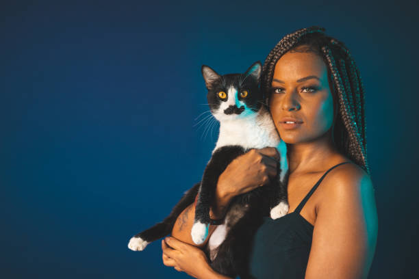 istock Afro woman holding a cat 1360617506