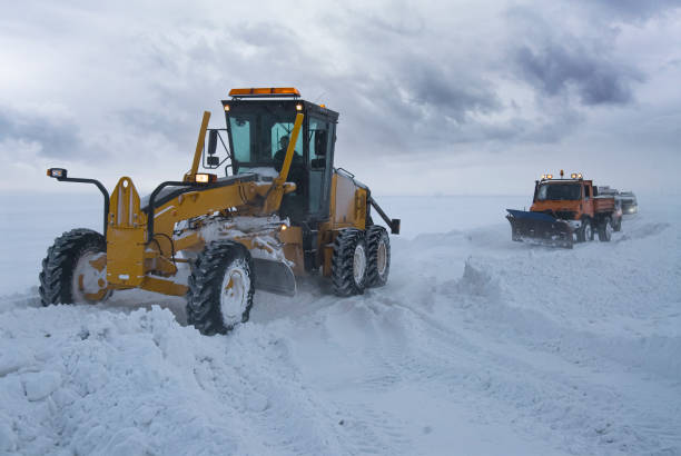 istock Construction machine trying to open the highway that was closed due to a snowstorm. 1360617654