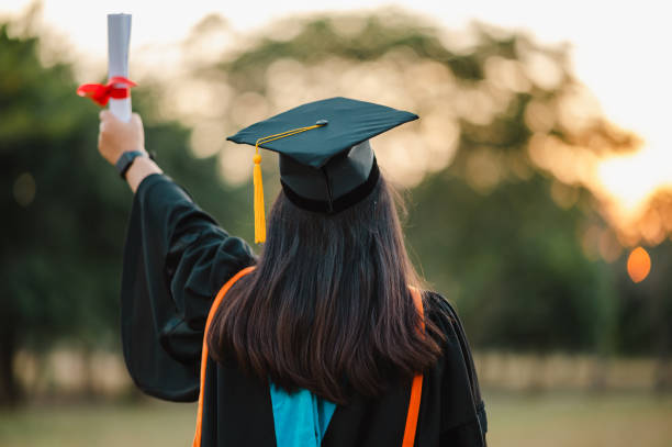 istock graduates wearing black hats holding university graduation certificates,Concept education congratulation. Graduation Ceremony ,Congratulated the graduates in University. 1360619009