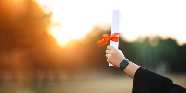 istock graduates wearing black hats holding university graduation certificates,Concept education congratulation. Graduation Ceremony ,Congratulated the graduates in University. 1360619012