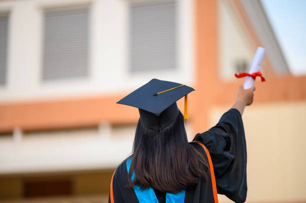 istock graduates wearing black hats holding university graduation certificates,Concept education congratulation. Graduation Ceremony ,Congratulated the graduates in University. 1360619023
