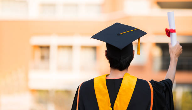 graduates wearing black hats holding university graduation certificates,Concept education congratulation. Graduation Ceremony ,Congratulated the graduates in University. stock photo