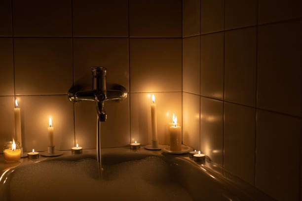 istock Romantic bathroom with candlelight foam in the dark 1360625572