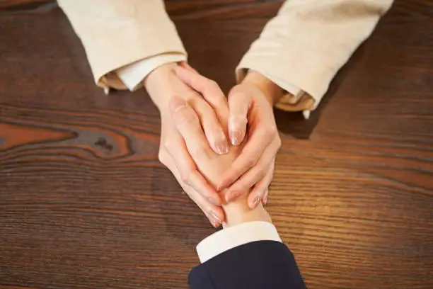 Photo of Female hand holding a male hand