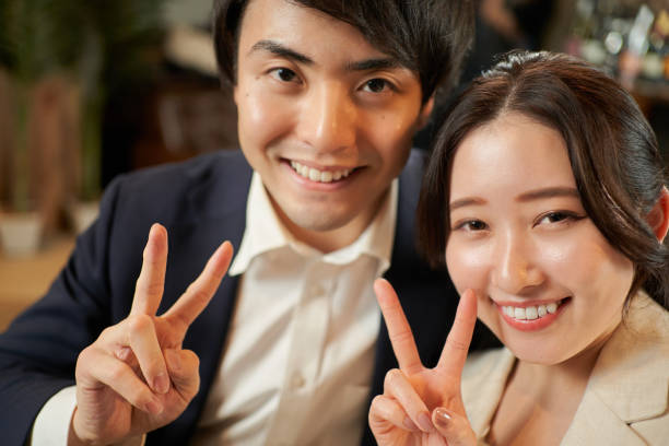 Asian couple making peace signs