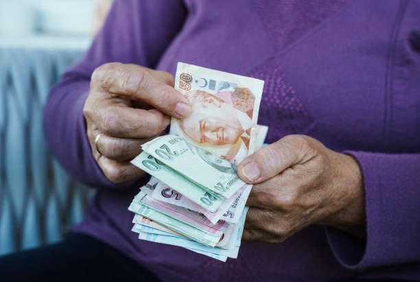 Retired woman counting Turkish Lira at home, close up stock photo