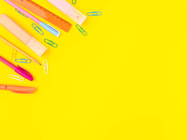 istock Back to school concept. Colorful writing stationery on yellow background 1360639913
