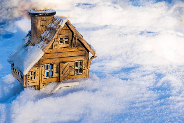 istock Ceramic model of a house in snow 1360641094