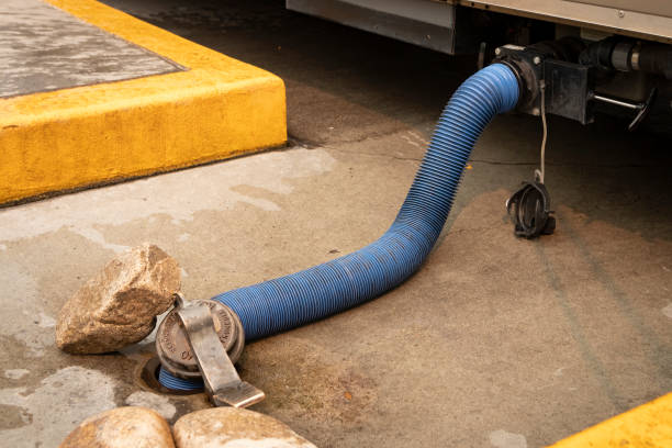 dump station sewer hose connected to RV stock photo