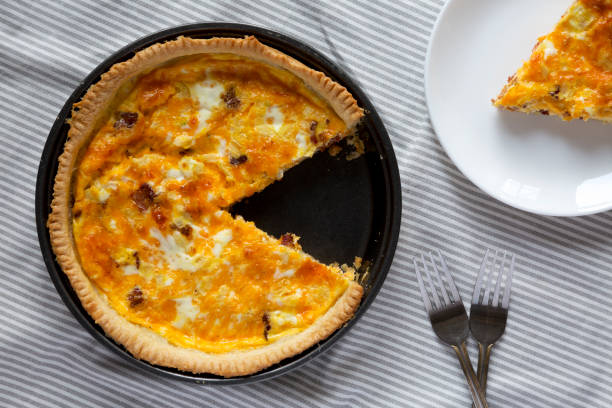 istock Homemade Bacon Quiche with Eggs and Cheddar Cheese, view from above. Flat lay, overhead, top view. 1360643579