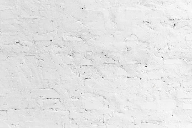 istock Texture of white wall of bricks and cement mortar 1360648048