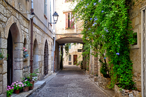 Old cobblestone romantic street of Antibes traditional for French Riviera