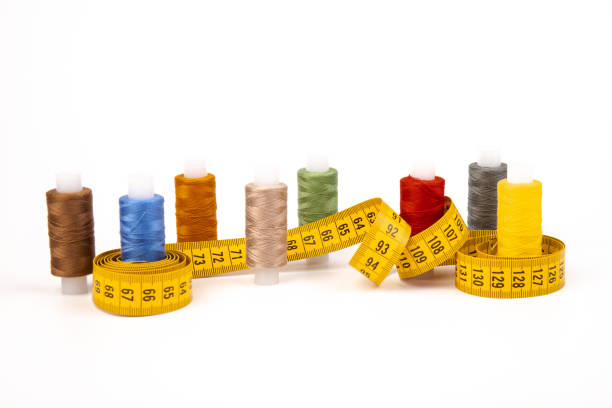 istock Sewing threads, sewing centimeter or measuring tape, isolated on white background. 1360655135