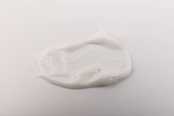 White smear of cosmetic cream isolated on light background. White smear of cosmetic cream isolated on light background. Creamy foundation texture. Smear of face cream. Texture of cream background makeup swipes stock pictures, royalty-free photos & images