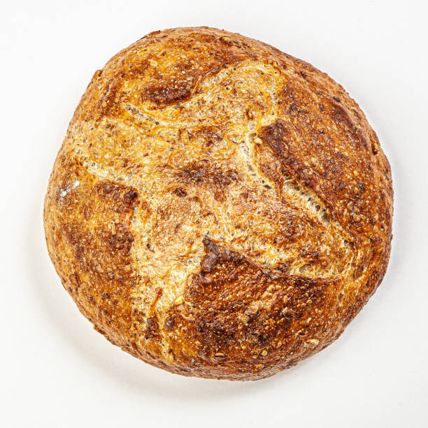 istock Hand made fresh round bread isolated on white background 1360657147