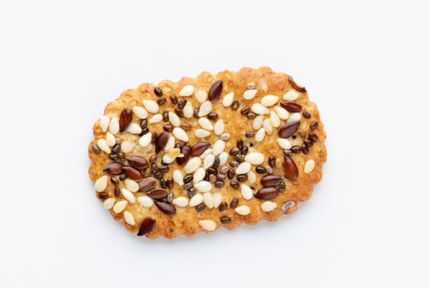 Salted crispy crackers with sesame, sunflower seeds isolated on white background.