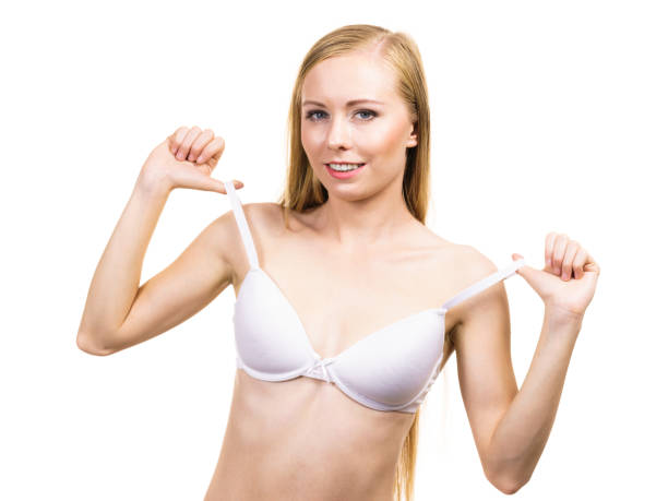 istock Young woman holding bra strap 1360659497