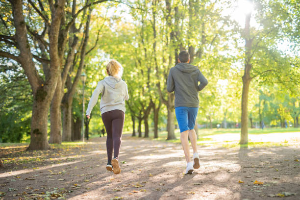 istock Couple running in public park 1360660439