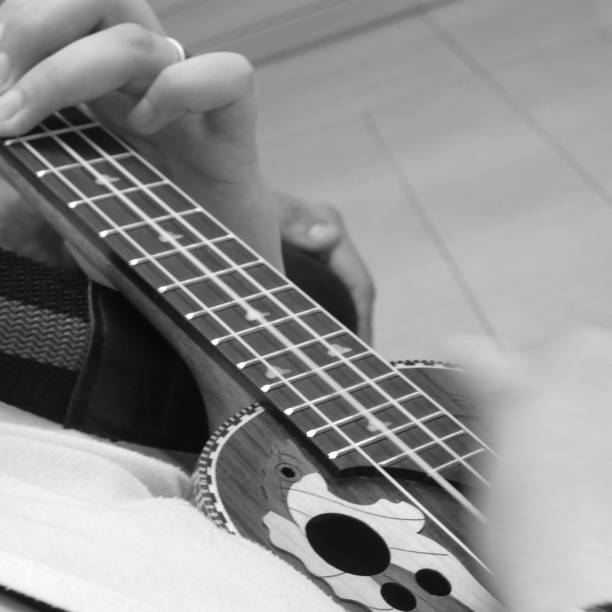 istock Person playing the ukulele 1360660548