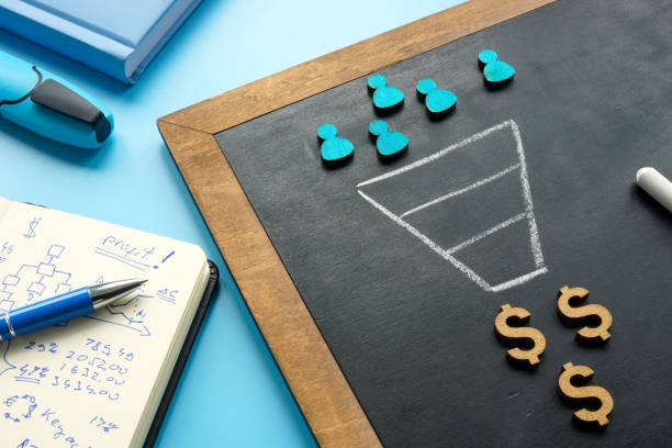 Marketing sales funnel on the blackboard and figurines. stock photo