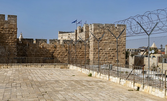 East Jerusalem, Palestine, May 1, 2019: View of the walls of the Old City in Jerusalem. The entire Old Town is listed as UNESCO World Heritage Site.