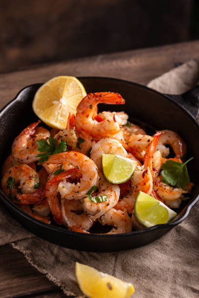 istock Grilled shrimps with greens and garlic in a pan 1360662561