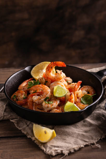 istock Grilled shrimps with greens and garlic in a pan 1360662564
