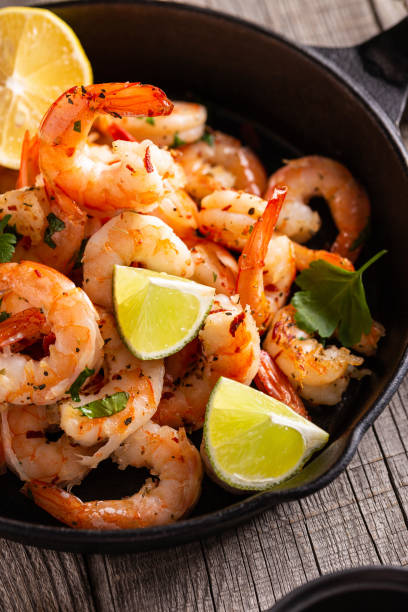 istock Grilled shrimps with greens and garlic in a pan 1360662574