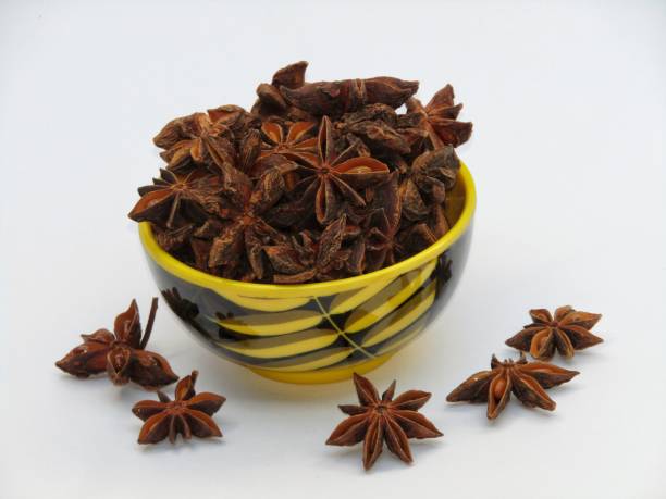 istock Star anise in a bowl on white background 1360662652