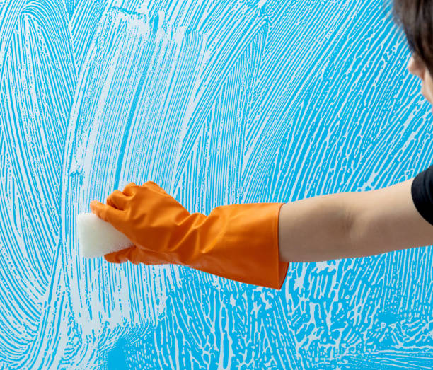 istock Cleaning glass window with sponge 1360663690