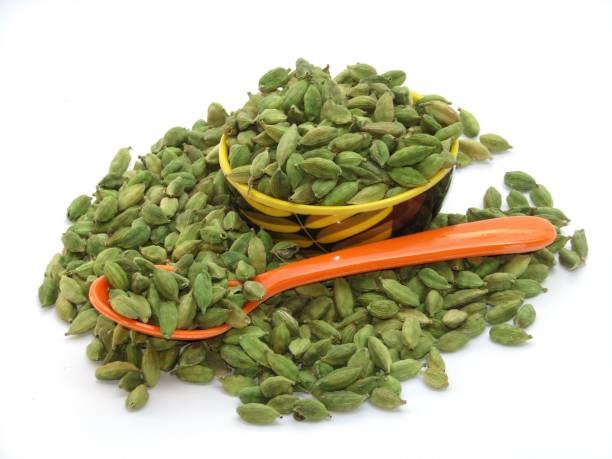 istock Cardamom in a bowl on white background 1360663720