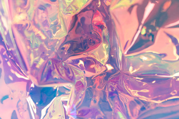 istock Pink glowing defocused holographic background. Wrinkled foil texture. 1360664574