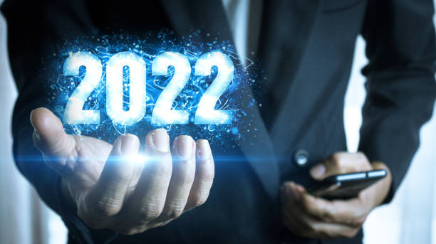 istock Businessman holding virtual image New Year's number 2022 1360664653