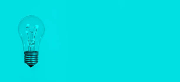 istock Light bulb on a blue background, long banner with space for text. 1360665712