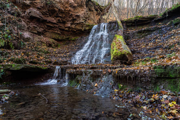 istock Tranquil waterfall scenery in the middle of autumn forest 1360669822