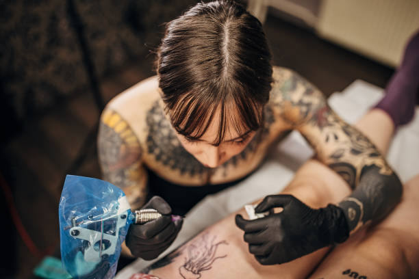 istock Beautiful female tattoo artist working 1360671261