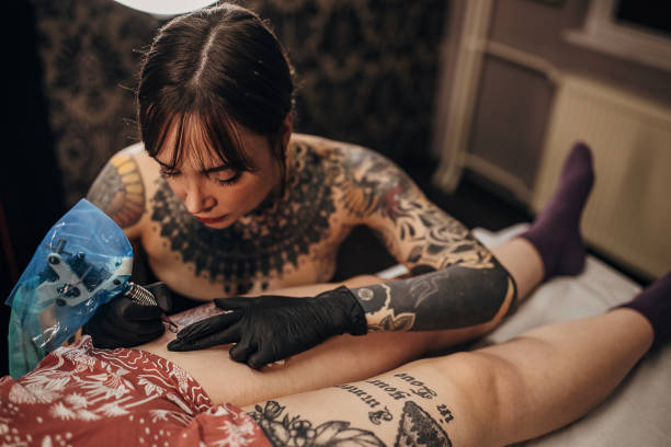 istock Female tattoo artist working 1360672284