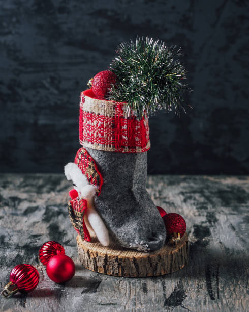 istock Christmas boot with red balls and tinsel, greeting card 1360673304