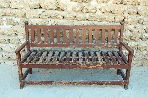 Old wooden beautiful bench in the street. Close-up. Isolated.