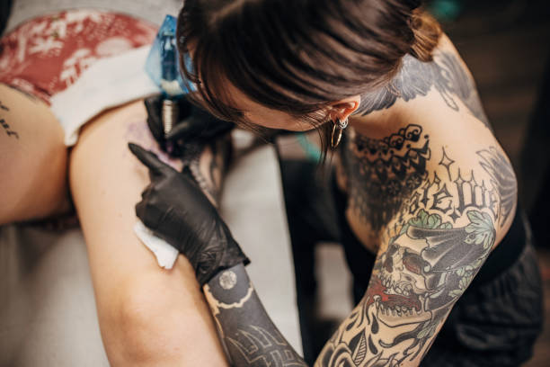 istock Female tattoo artist working 1360676848