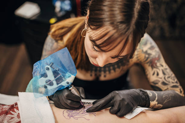 istock Female tattoo artist working 1360676879