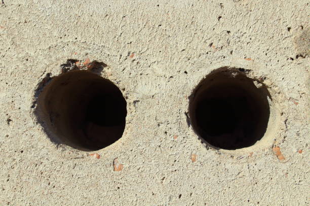 istock Gray brick with two holes. Close-up. Background. Texture. 1360678718