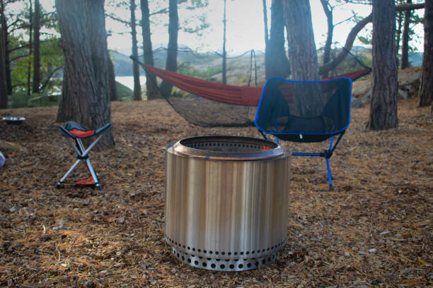 istock Forest Campsite with Fire Pit, Camp Chairs, and Hammock in Stavanger Norway. Camping Theme 1360679051