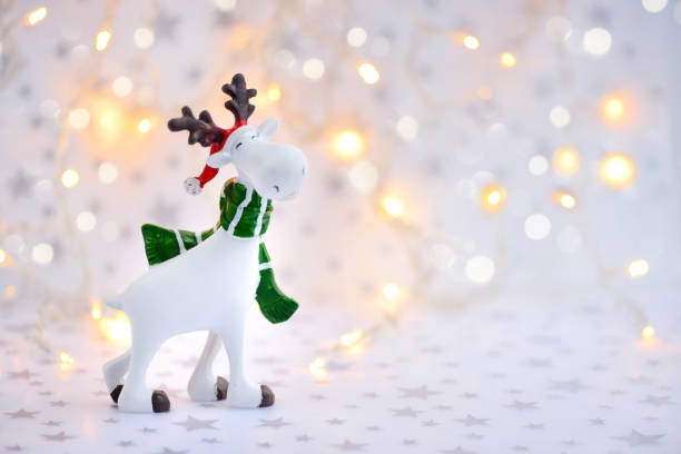 istock Christmas background with decorative moose on festive lights background 1360679100