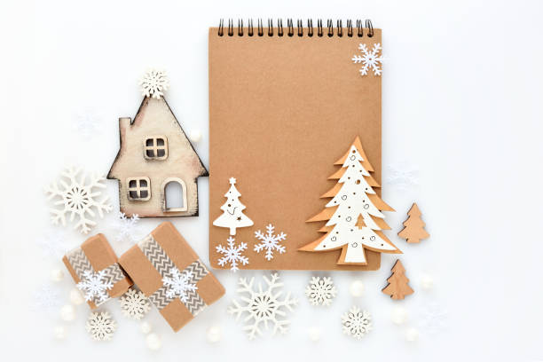 istock Christmas or New Year greeting card. The notebook with christmas decorations on white background. Flat lay, top view, copy space 1360679655