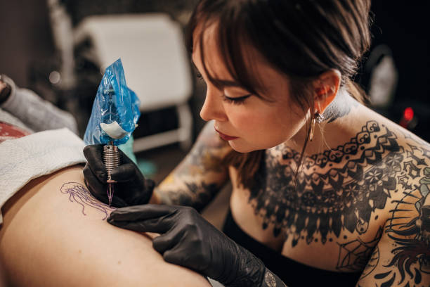 istock Female tattoo artist working 1360681309