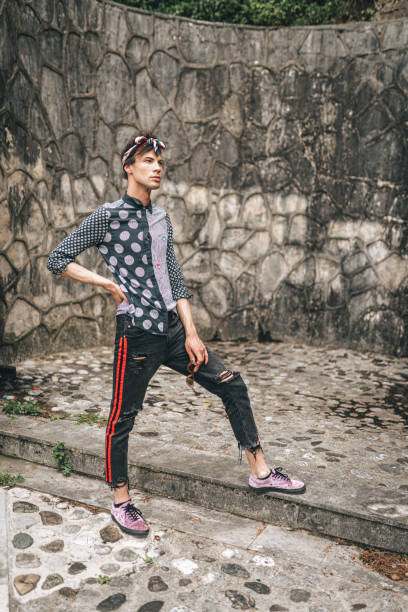 istock Young transsexual man with sunglasses posing outdoors 1360681954