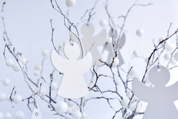 White branches with christmas angels. Festive background