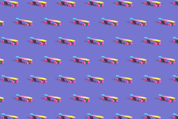istock Pattern made of rainbow plastic skateboard on purple background 1360682396